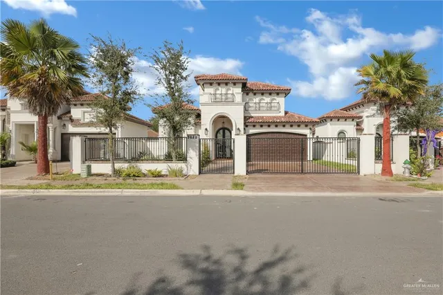a front view of a building with a garden and plants