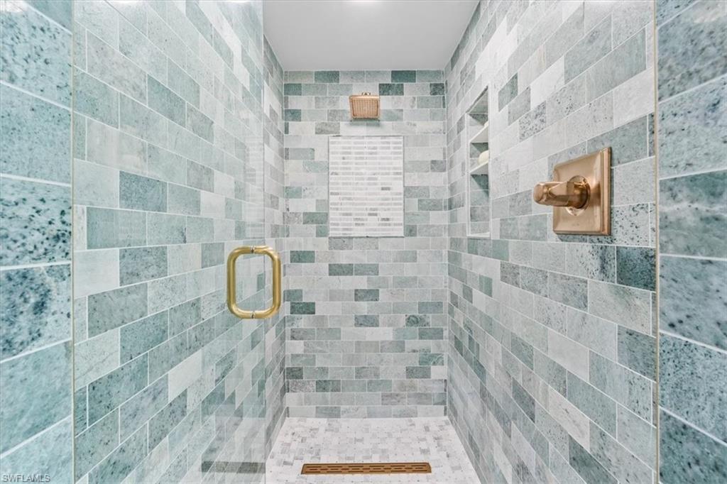 6573 Marissa Loop, Unit 1002 Naples, FL 34108 - Photo 11 of 24 a bathroom with a shower