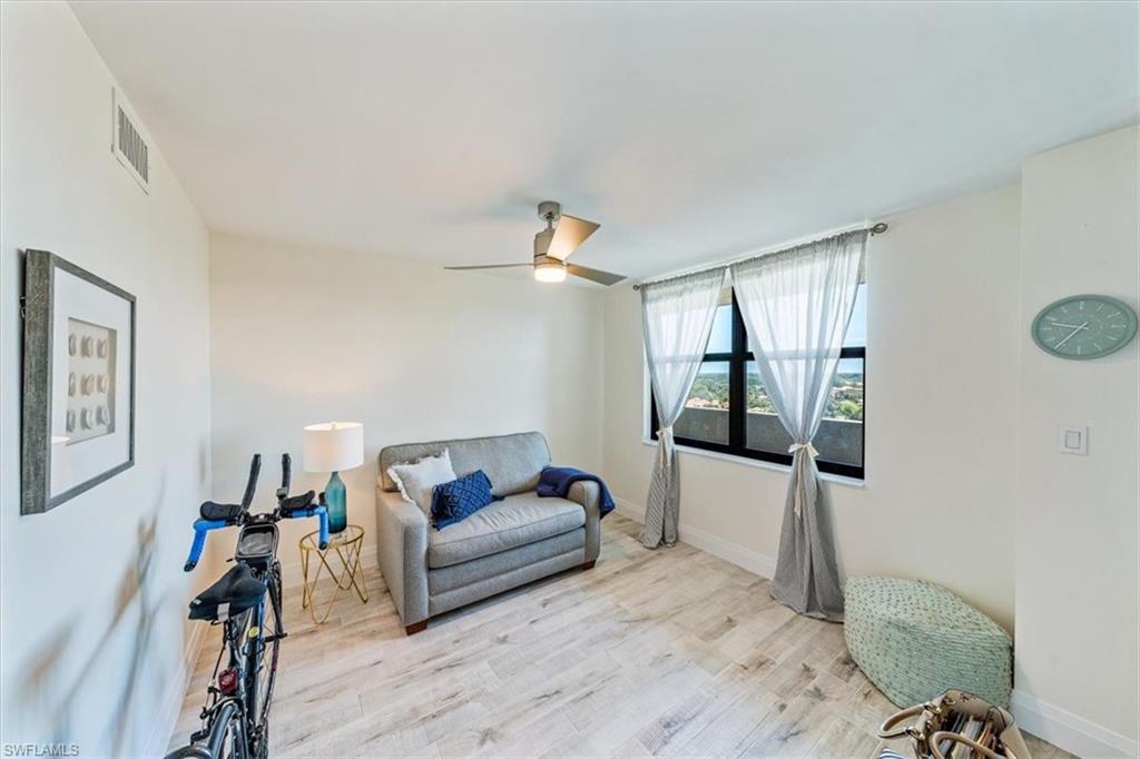 6573 Marissa Loop, Unit 1002 Naples, FL 34108 - Photo 12 of 24 a living room with furniture and a flat screen tv