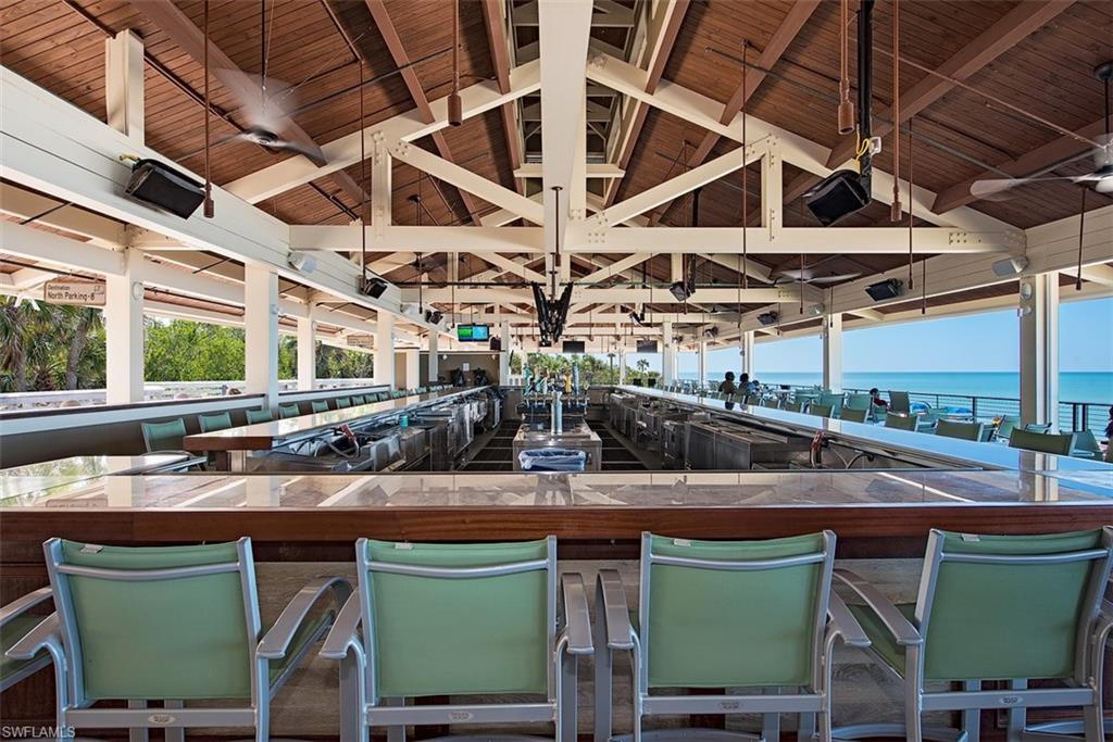 6573 Marissa Loop, Unit 1002 Naples, FL 34108 - Photo 19 of 24 a room with lots of wooden furniture and a sink