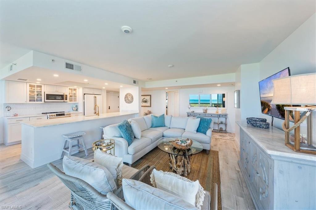 6573 Marissa Loop, Unit 1002 Naples, FL 34108 - Photo 24 of 24 a living room with furniture and a wooden floor