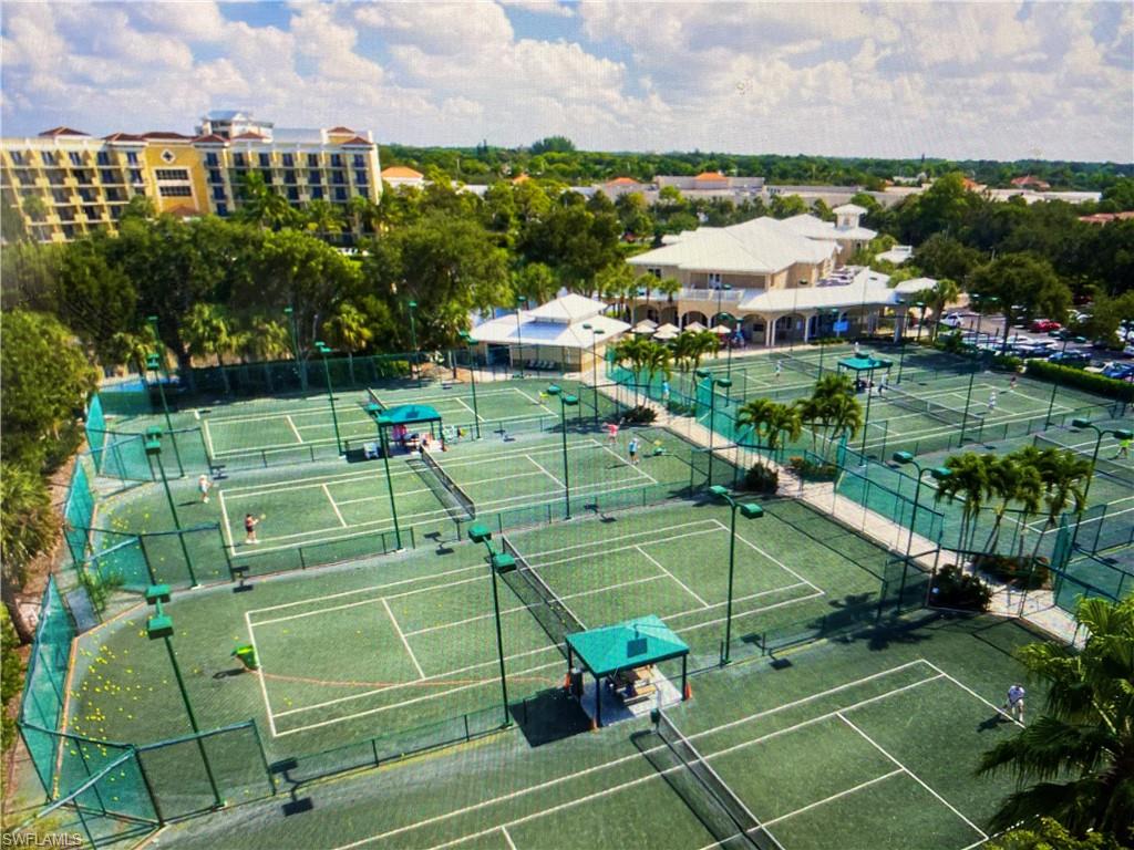 6573 Marissa Loop, Unit 1002 Naples, FL 34108 - Photo 23 of 24 a view of a tennis ground and a cars park