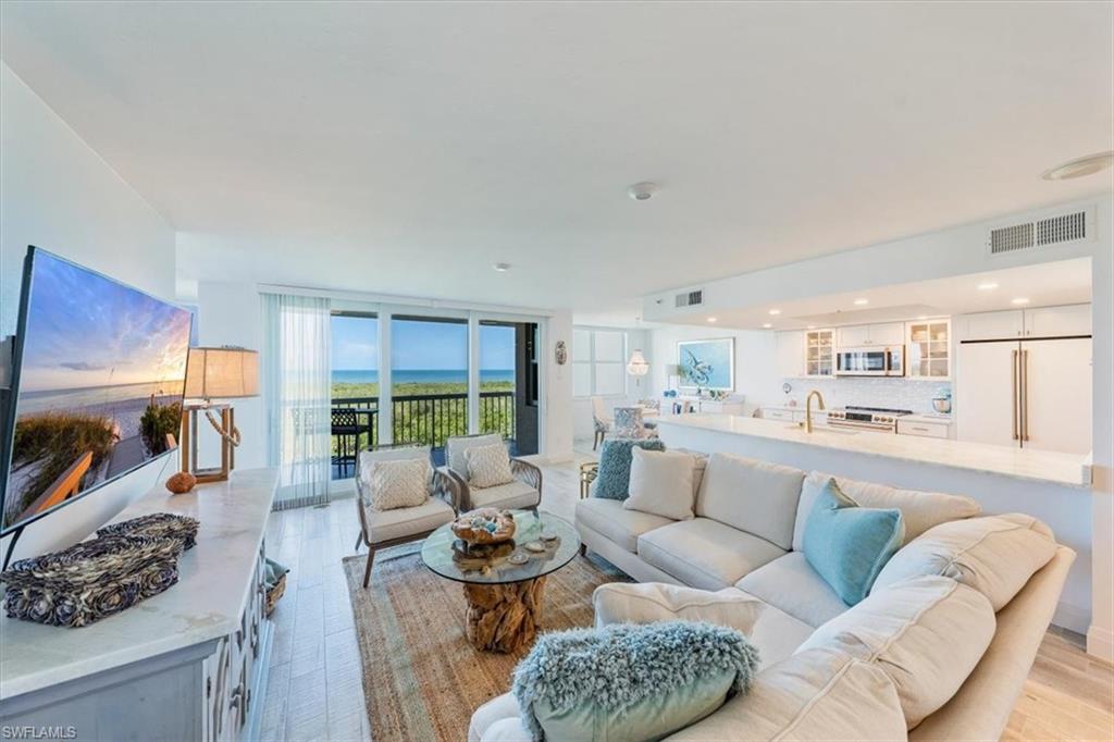 6573 Marissa Loop, Unit 1002 Naples, FL 34108 - Photo 3 of 24 a living room with furniture and a large window