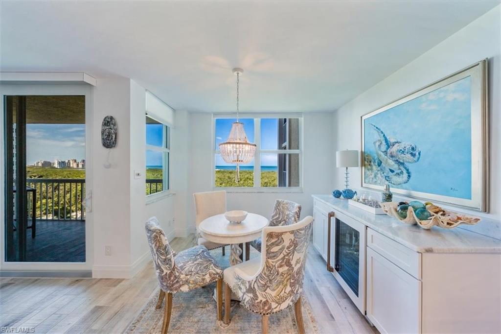 6573 Marissa Loop, Unit 1002 Naples, FL 34108 - Photo 6 of 24 a view of a dining room with furniture window and wooden floor
