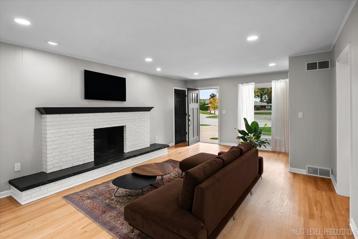 27 South Canterbury Road Aurora, IL 60506 - Photo 11 of 39 a living room with furniture a flat screen tv and a fireplace