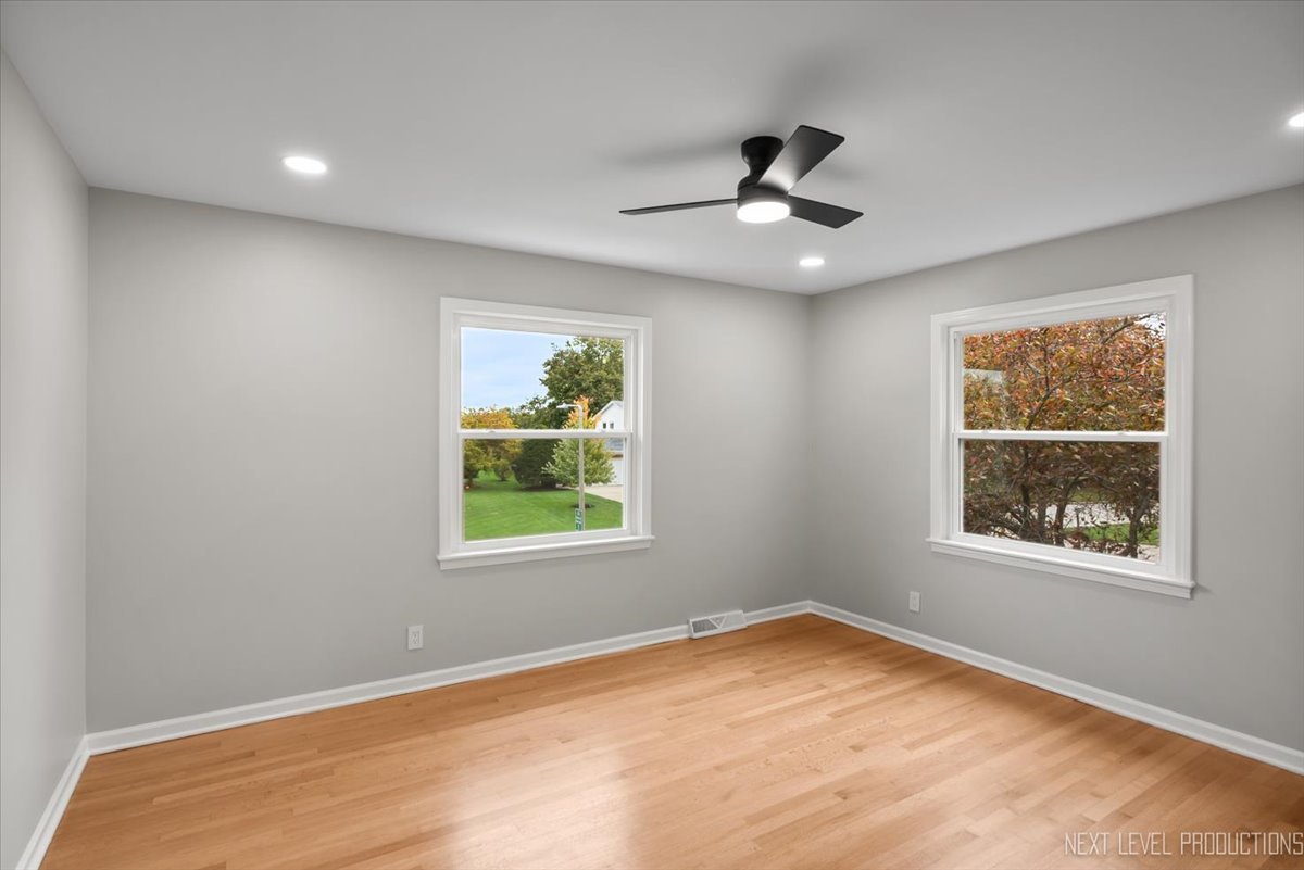 27 South Canterbury Road Aurora, IL 60506 - Photo 23 of 39 an empty room with a window and a ceiling fan