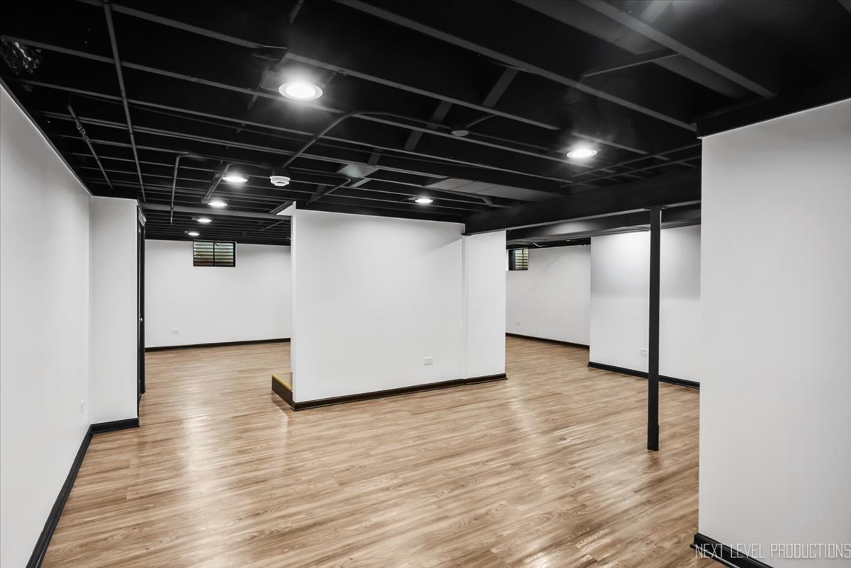 27 South Canterbury Road Aurora, IL 60506 - Photo 24 of 39 a view of an empty room with wooden floor