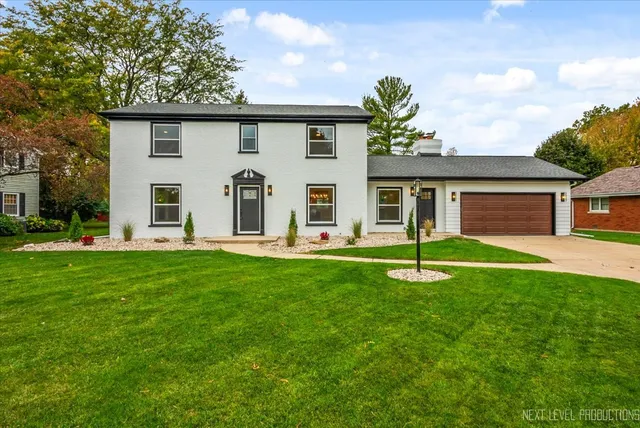 a front view of house with yard outdoor seating and green space