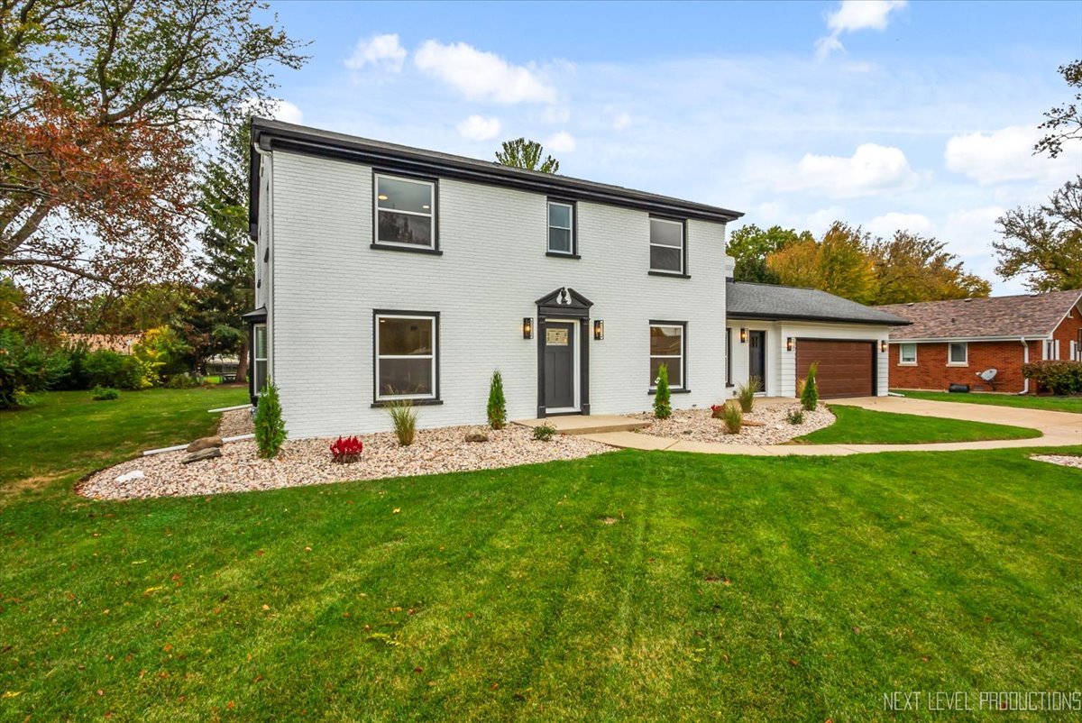 27 South Canterbury Road Aurora, IL 60506 - Photo 33 of 39 a front view of house with yard outdoor seating and green space