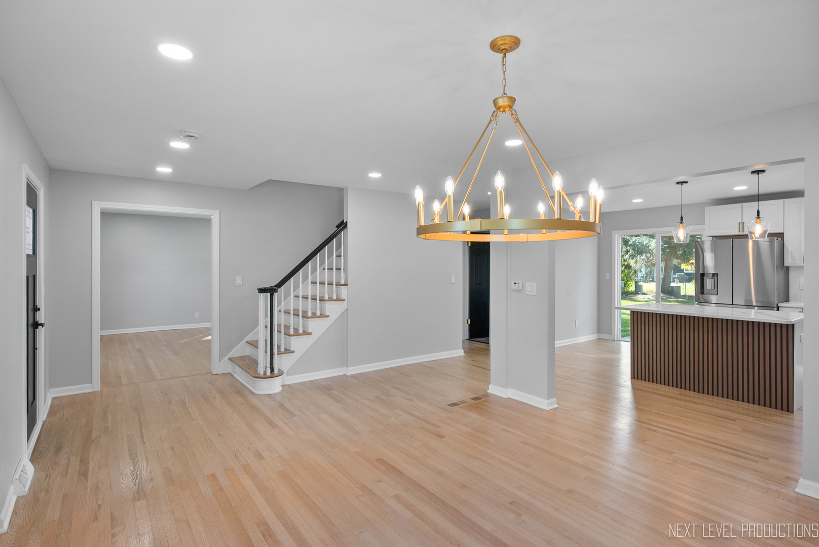 27 South Canterbury Road Aurora, IL 60506 - Photo 10 of 39 a view of a room with wooden floor and staircase