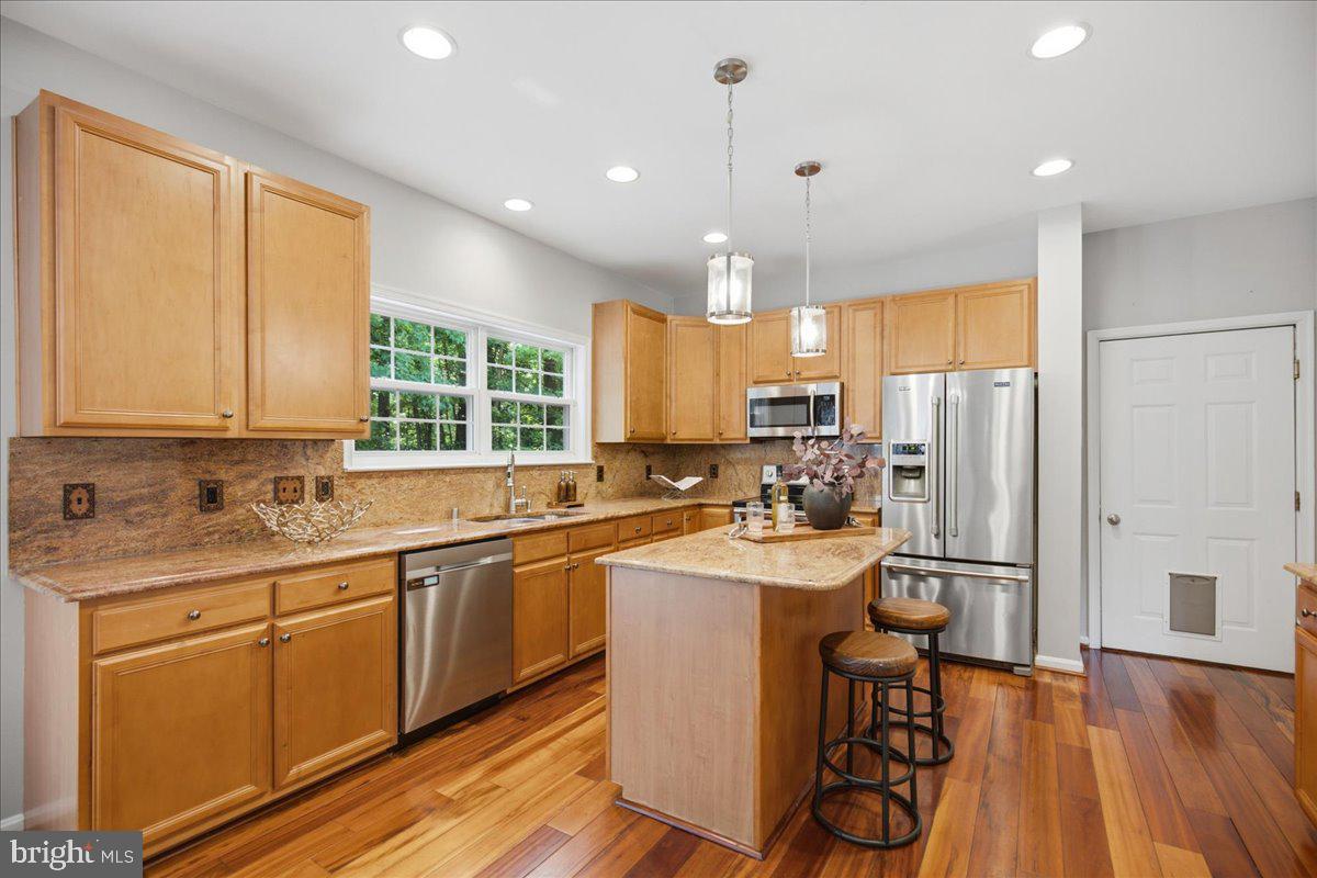 2424 Springbrook Court Huntingtown, MD 20639 - Photo 32 of 103 a kitchen with sink cabinets and wooden floor