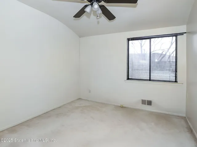 a bedroom with bed and a window