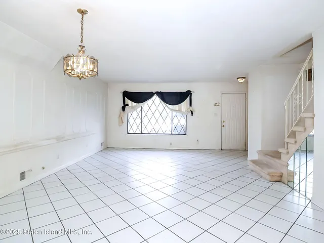 a view of an empty room with stairs