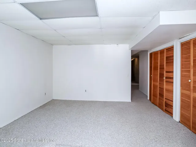 a front view of a building with a yard and garage