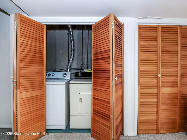 a view of a house with a yard and potted plants