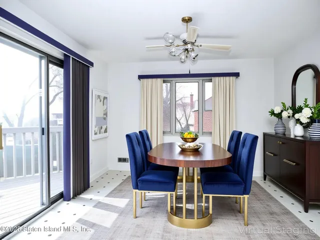 a view of an empty room with a ceiling fan and windows