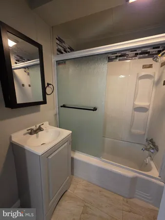 a bathroom with a sink toilet and mirror