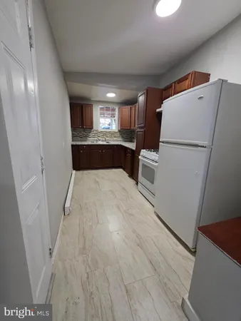 a view of a kitchen from a hallway