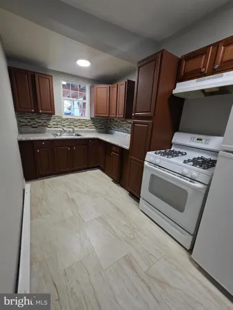 a kitchen with a stove and a refrigerator