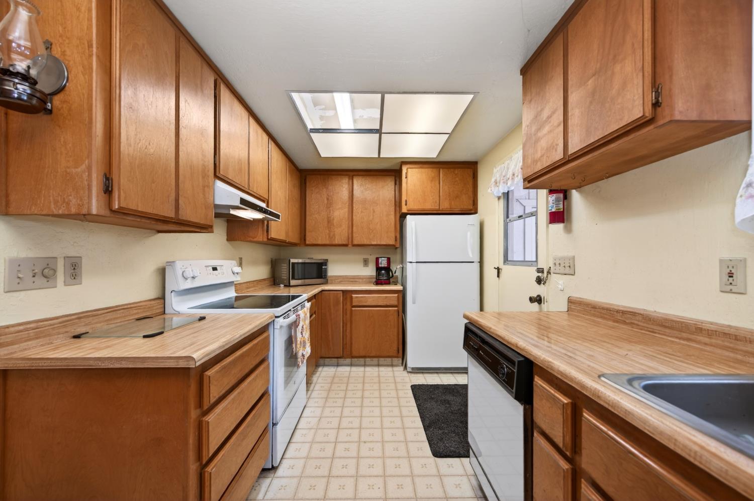 20191 Kit Court Volcano, CA 95689 - Photo 26 of 54 a kitchen with refrigerator cabinets and a sink