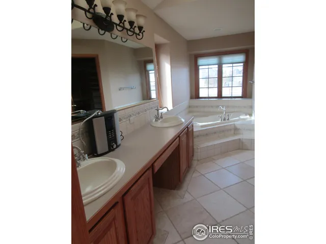 a bathroom with a sink double vanity and a mirror