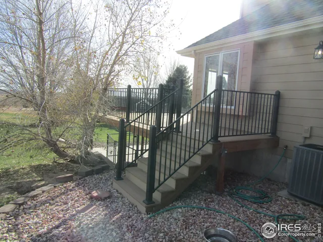 a view of a gate with a yard and wooden fence
