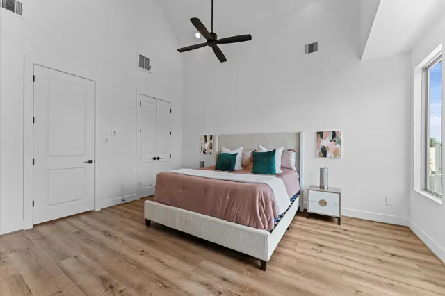 a bedroom with a bed and wooden floor