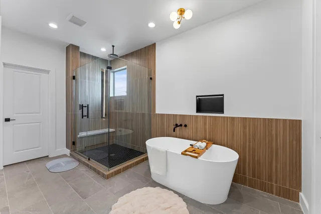 a bathroom with a bathtub and shower