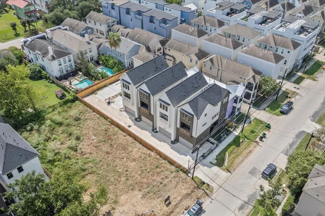 an aerial view of a house with a yard