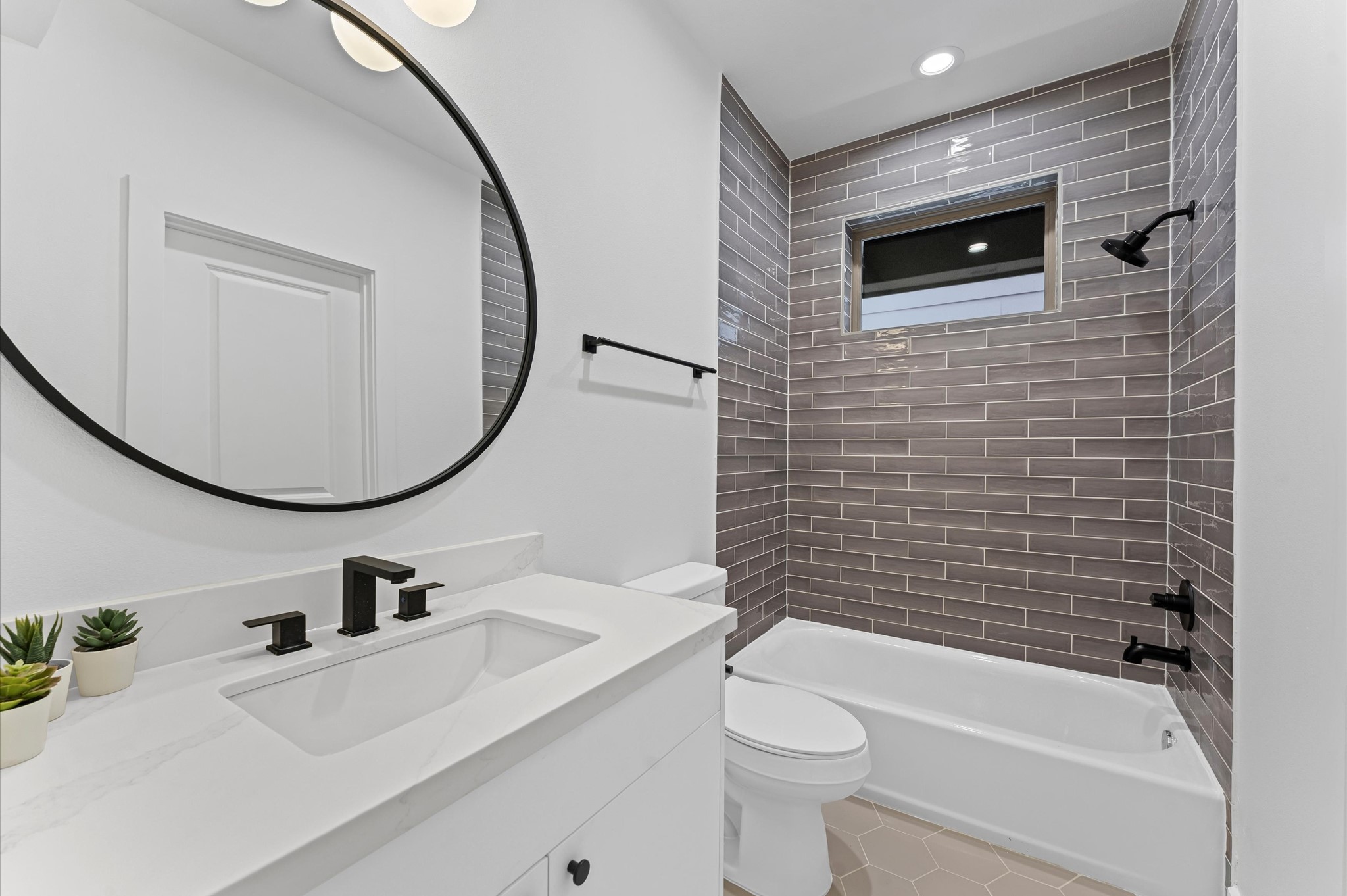 1122 West 17th Street, Unit E Houston, TX 77008 - Photo 6 of 37 a bathroom with a sink a toilet and a mirror