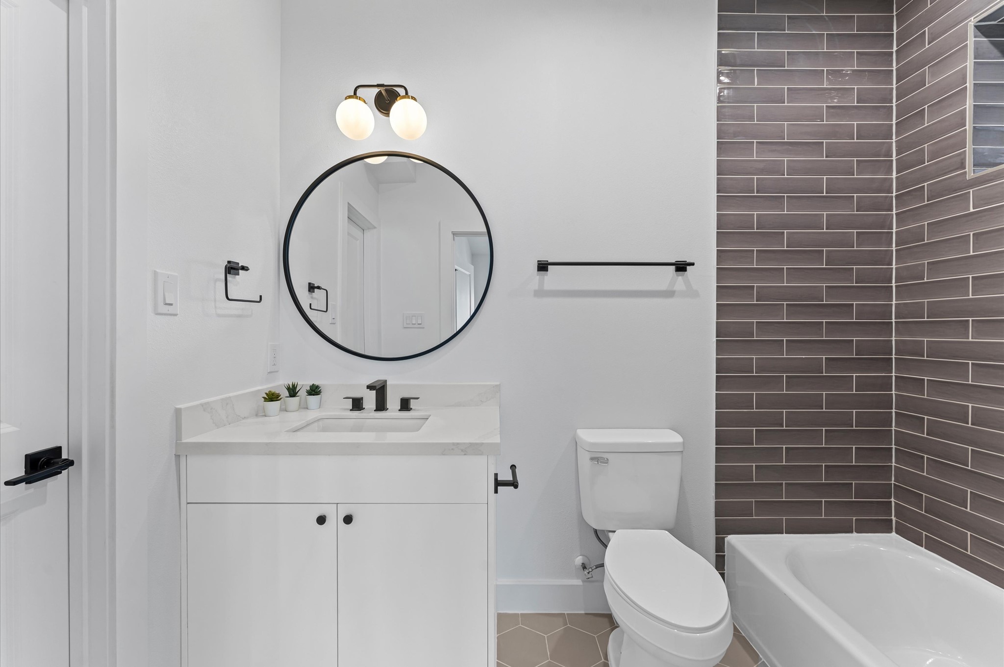 1122 West 17th Street, Unit E Houston, TX 77008 - Photo 7 of 37 a bathroom with a sink a toilet and a mirror