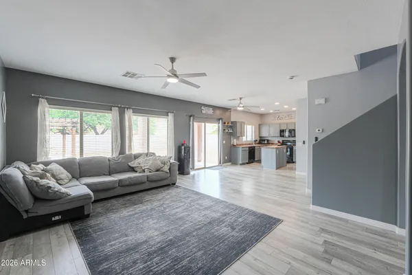 a living room with furniture and a wooden floor