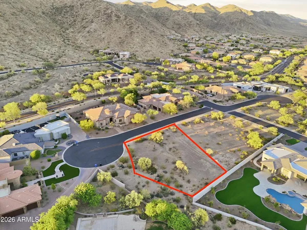 an aerial view of water body with residential house and outdoor space