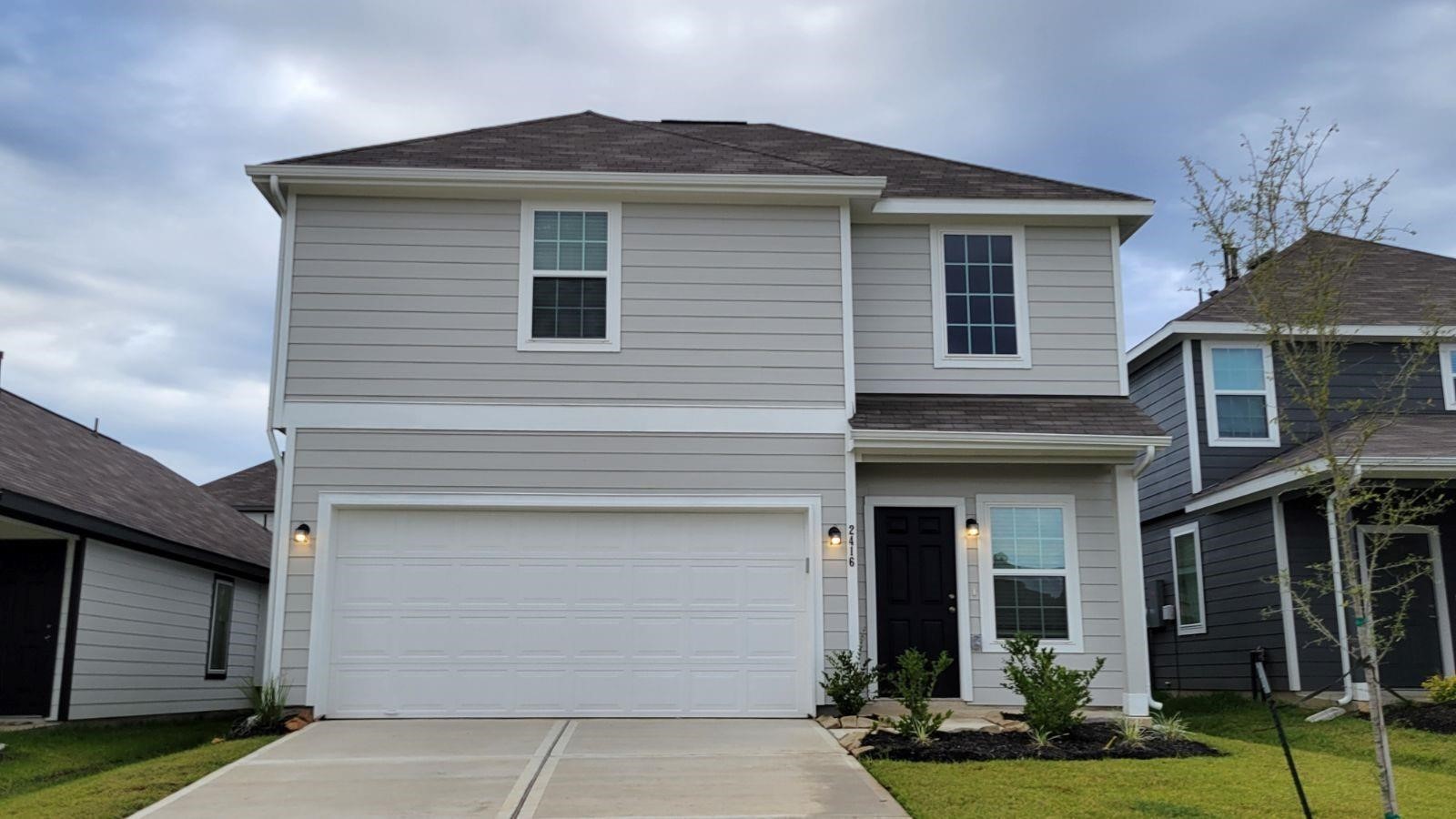 2416 Bluefish Court Conroe, TX 77384 - Photo 1 of 45 a front view of a house with garden