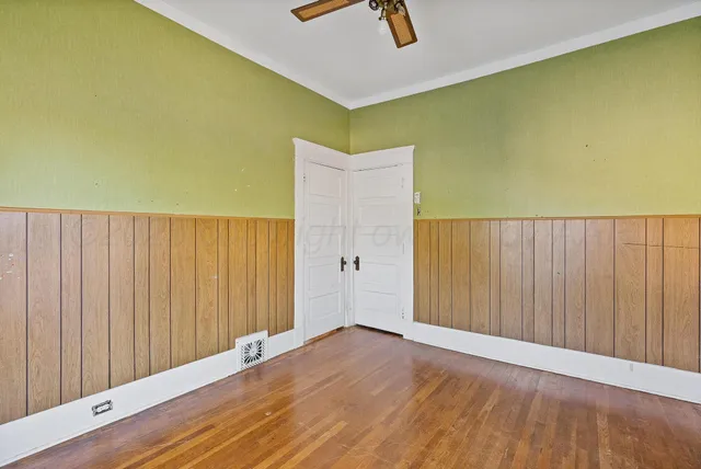 a view of a room with wooden floor