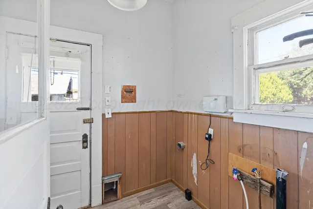 a view of a hallway and wooden shelves