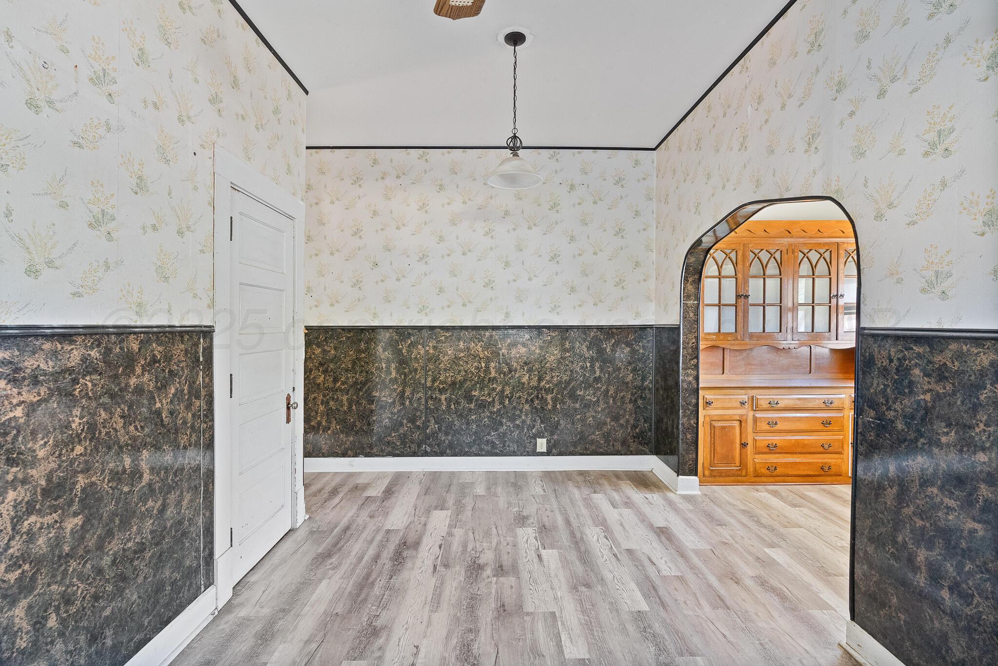 4124 Crockett Street Amarillo, TX 79110 - Photo 9 of 25 a view of empty room with wooden floor and fan