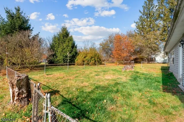 a backyard of a house with yard and outdoor seating