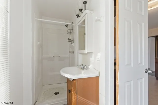 a bathroom with a sink a mirror and shower