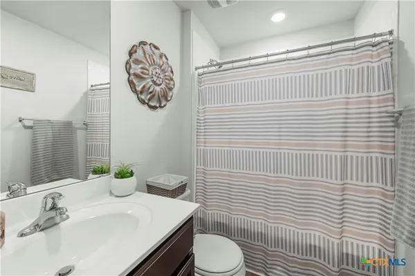 a bathroom with a sink toilet and mirror