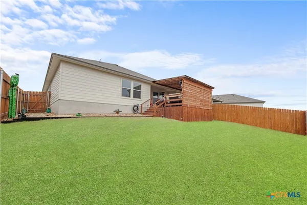 a view of a backyard with plants and a garden