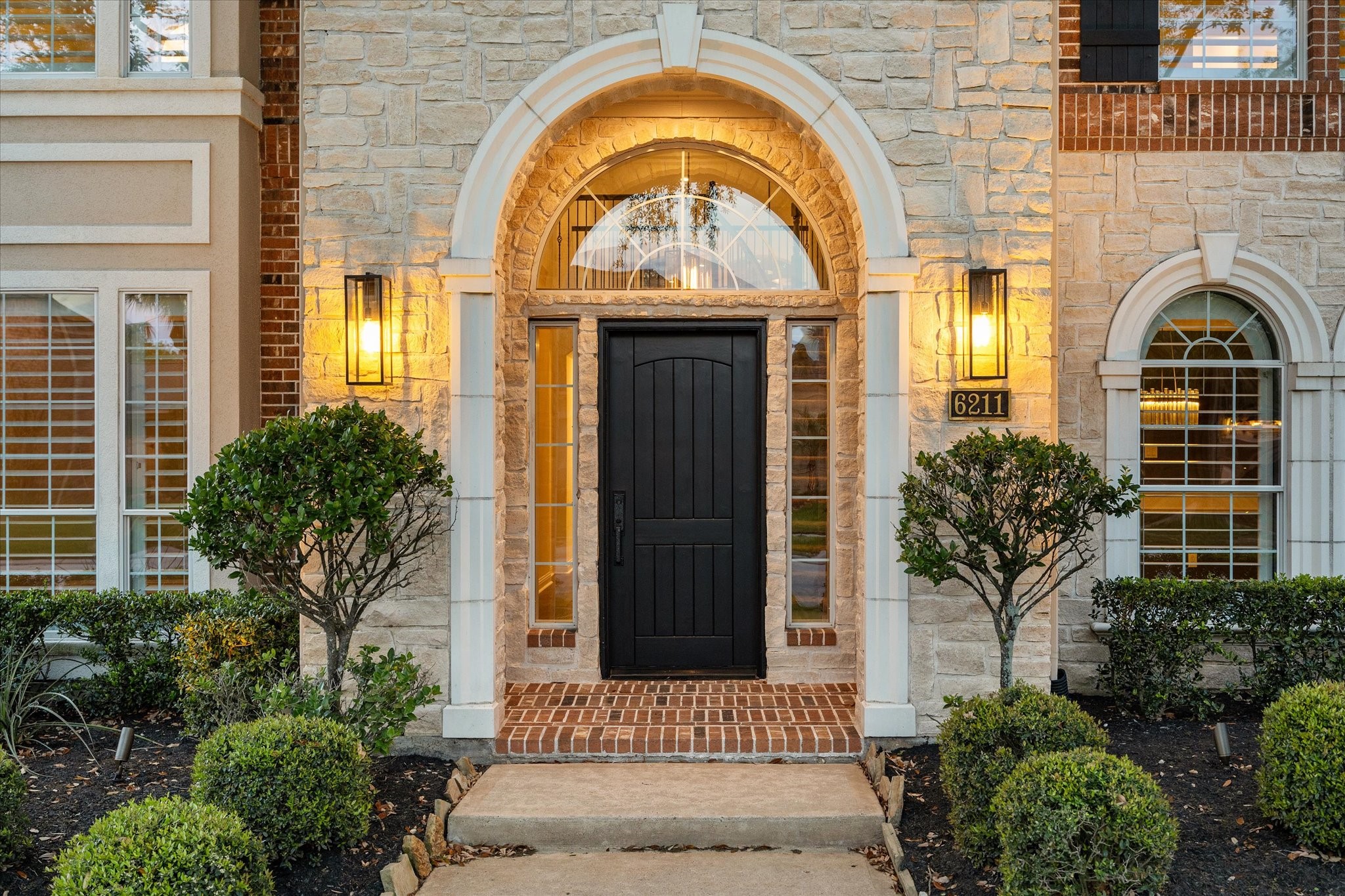 6211 Alameda Point Lane Houston, TX 77041 - Photo 4 of 50 Grand arched entry with elegant brick detail and manicured topiary, first impressions that wow!