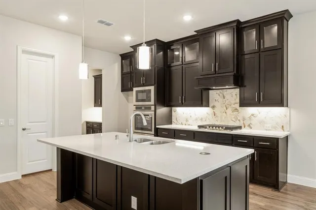 a kitchen with granite countertop a sink and cabinets