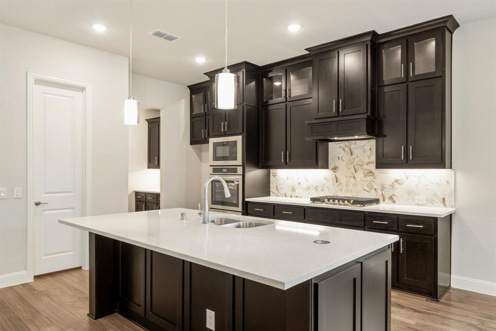 1113 Cardinal Drive Midlothian, TX 76065 - Photo 11 of 34 a kitchen with granite countertop a sink and cabinets