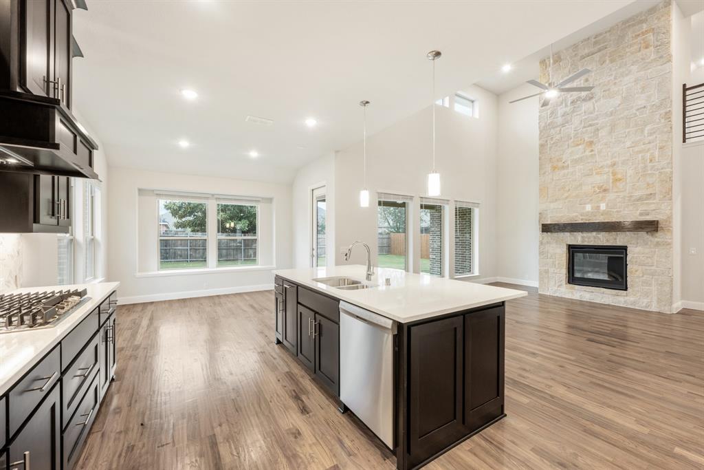 1113 Cardinal Drive Midlothian, TX 76065 - Photo 14 of 34 a kitchen with a stove and a wooden floor