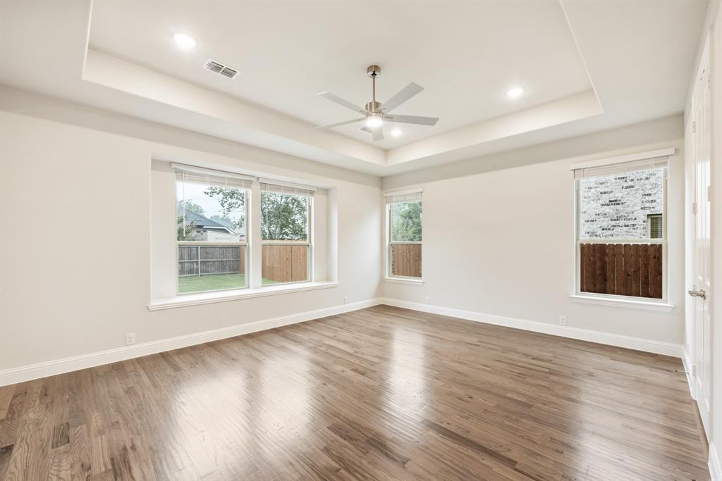1113 Cardinal Drive Midlothian, TX 76065 - Photo 15 of 34 a view of an empty room with wooden floor and a window