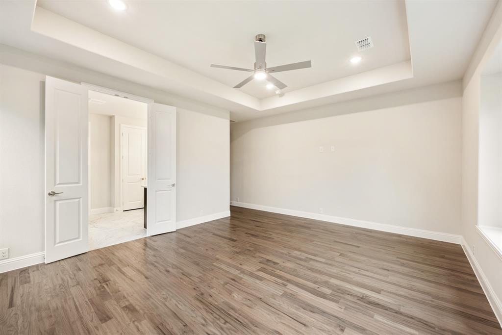 1113 Cardinal Drive Midlothian, TX 76065 - Photo 16 of 34 an empty room with wooden floor ceiling fan and windows