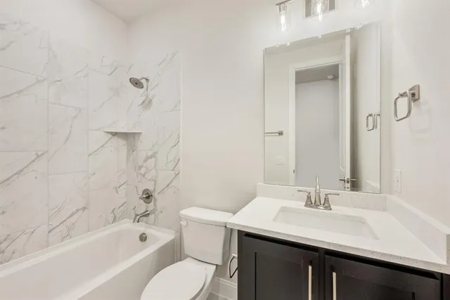 a bathroom with a sink toilet tub and shower