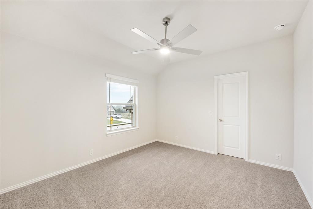 1113 Cardinal Drive Midlothian, TX 76065 - Photo 27 of 34 an empty room with window and ceiling fan