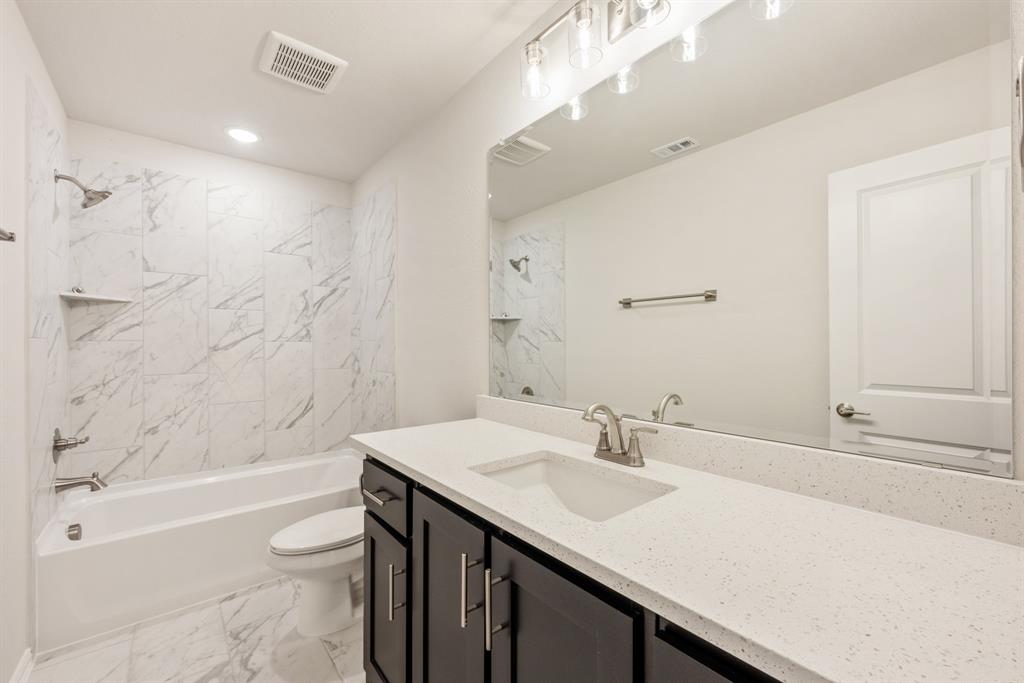 1113 Cardinal Drive Midlothian, TX 76065 - Photo 28 of 34 a bathroom with a sink a toilet and shower